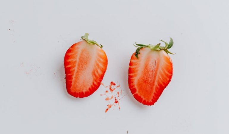 sliced strawberry on blue background