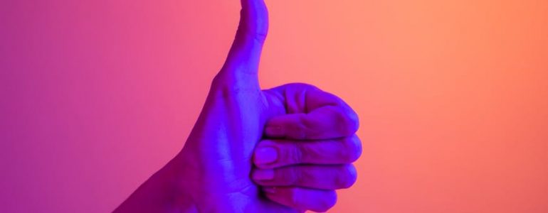 persons hand doing thumbs up